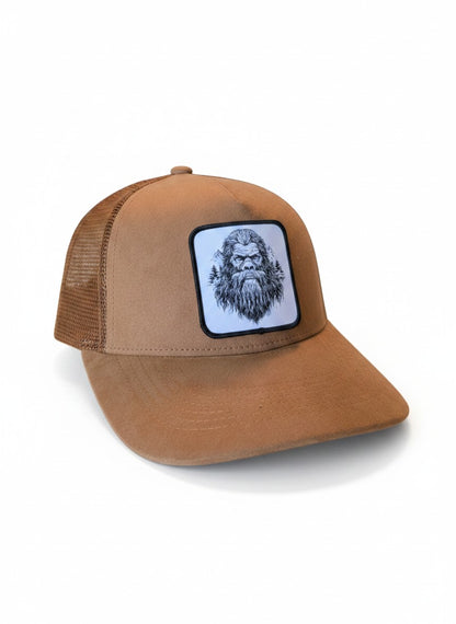 Moove Headwear brown suede trucker hat with Bigfoot graphic patch and mesh back. Adjustable snapback.