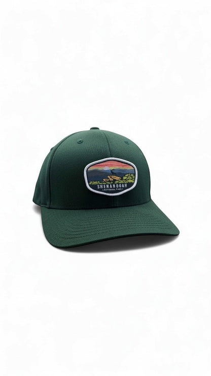 Moove Headwear dark green fitted cap with Shenandoah National Park sunset patch. Features curved brim and breathable eyelets.