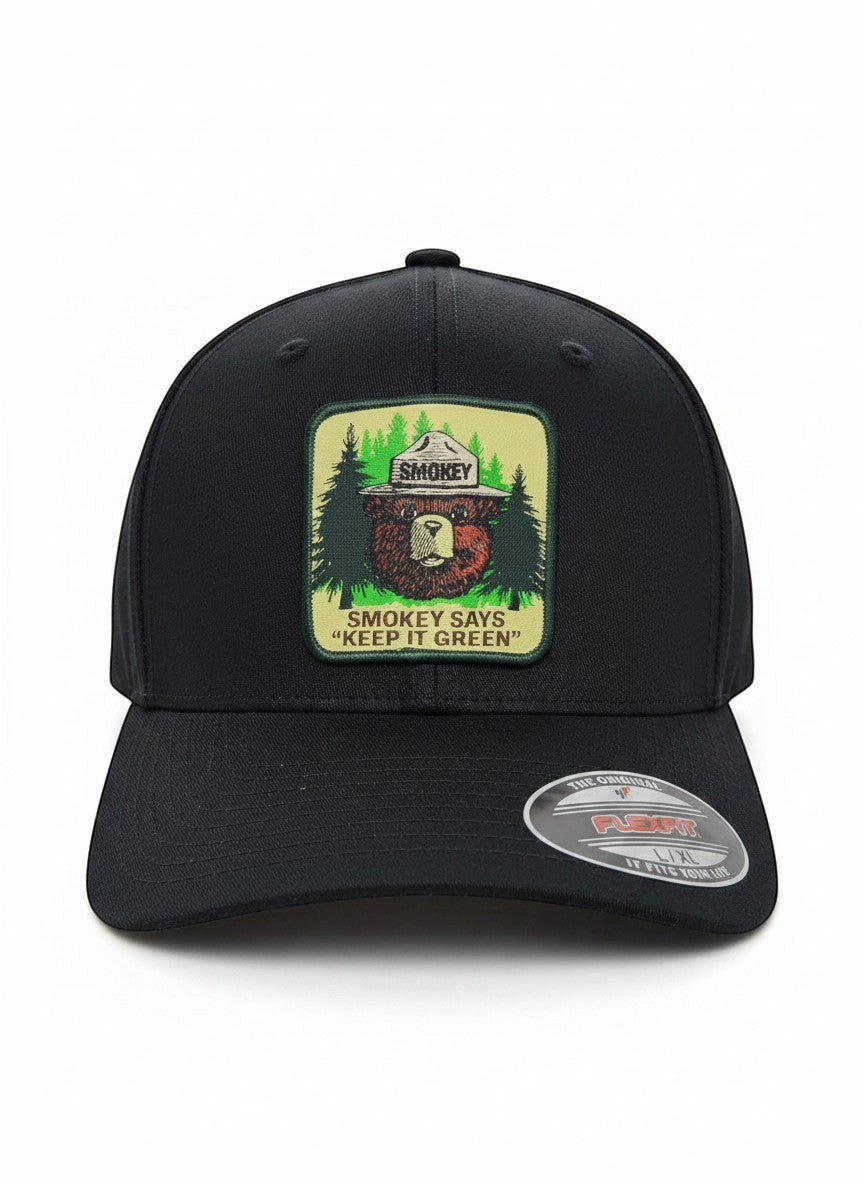 Moove Headwear black fitted baseball cap with Smokey Bear emblem and "Smokey Says Keep It Green" slogan.