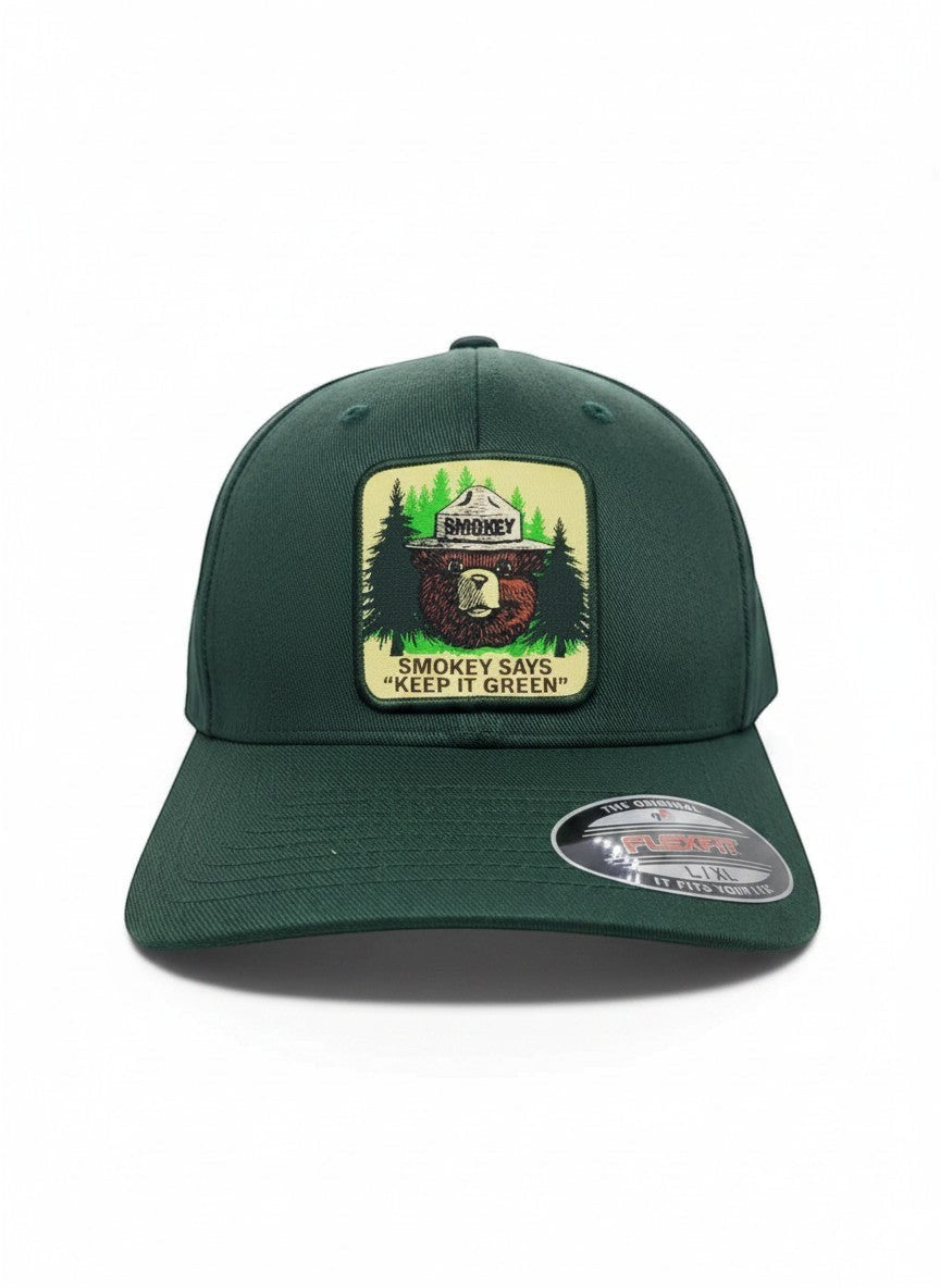 Moove Headwear dark green fitted baseball cap with Smokey Bear emblem and "Smokey Says Keep It Green" text.