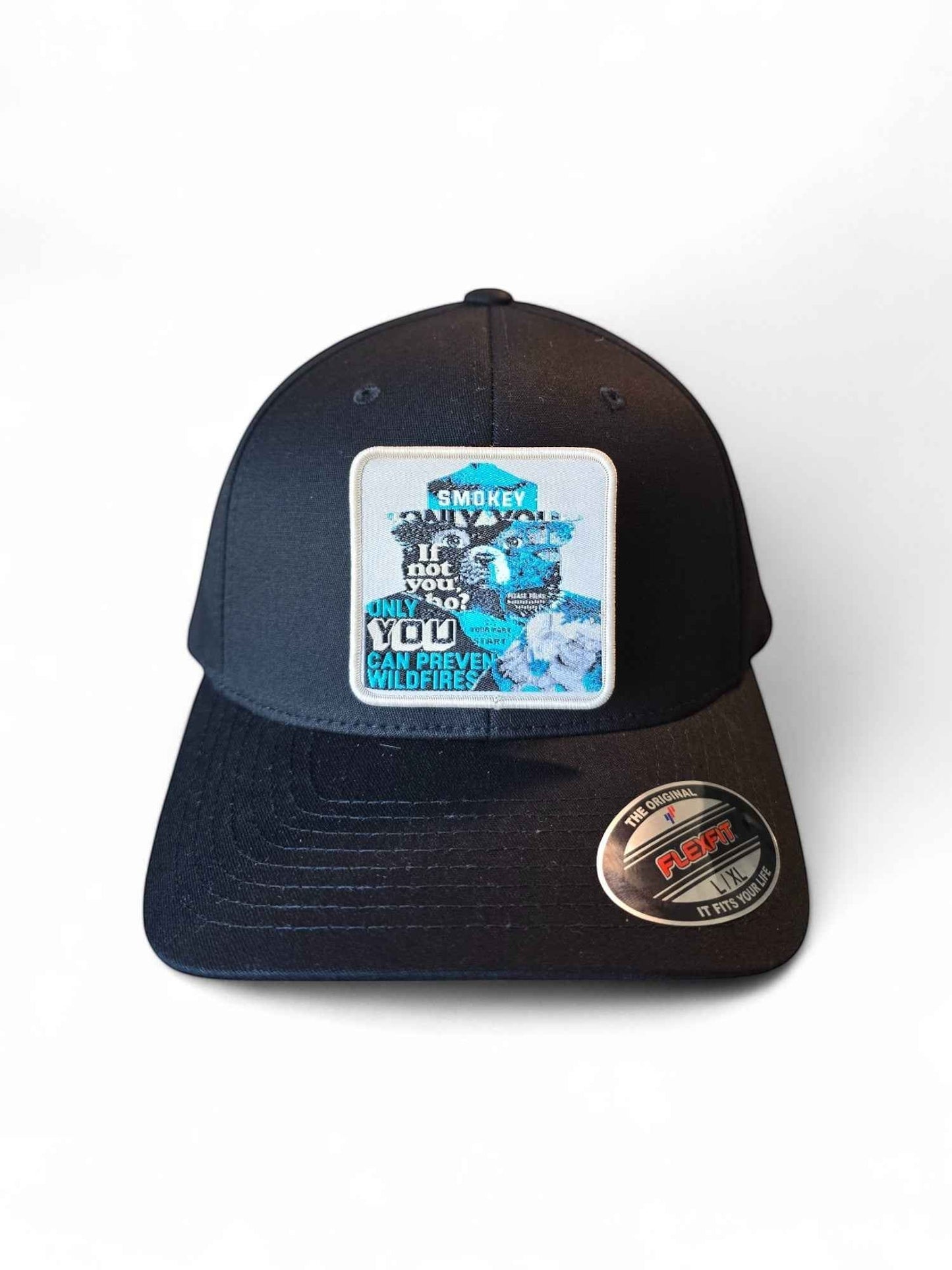 Moove Headwear black Flexfit hat with Smokey Bear wildfire prevention patch and "Only You Can Prevent Wildfires" slogan.