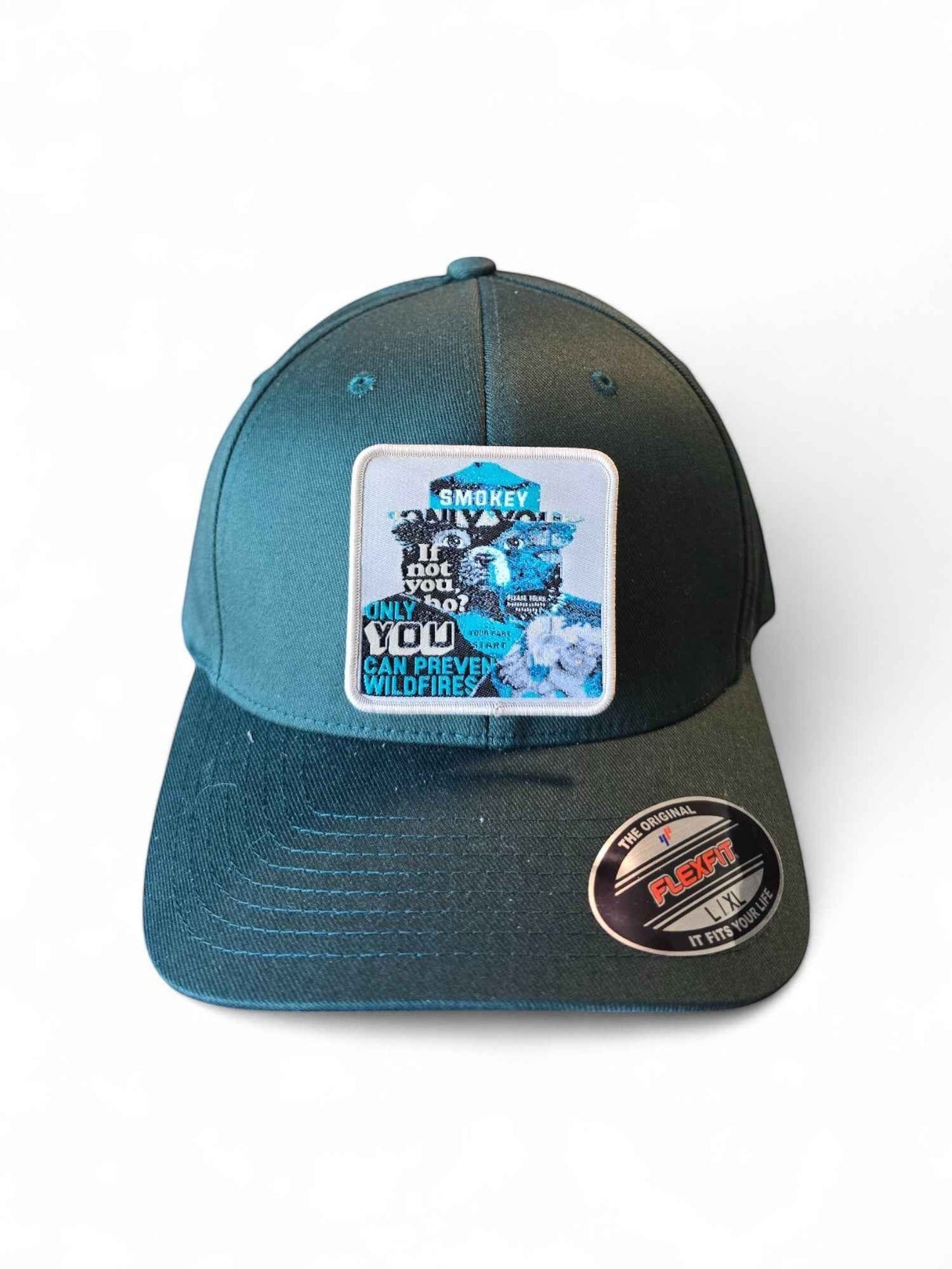 Moove Headwear dark teal fitted baseball cap with Smokey Bear wildfire prevention patch. Structured crown, mid-profile.