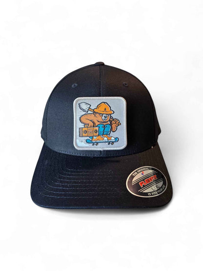 Moove Headwear black fitted hat with Smokey Bear skateboarding patch. Features Flexfit stretch-fit comfort.