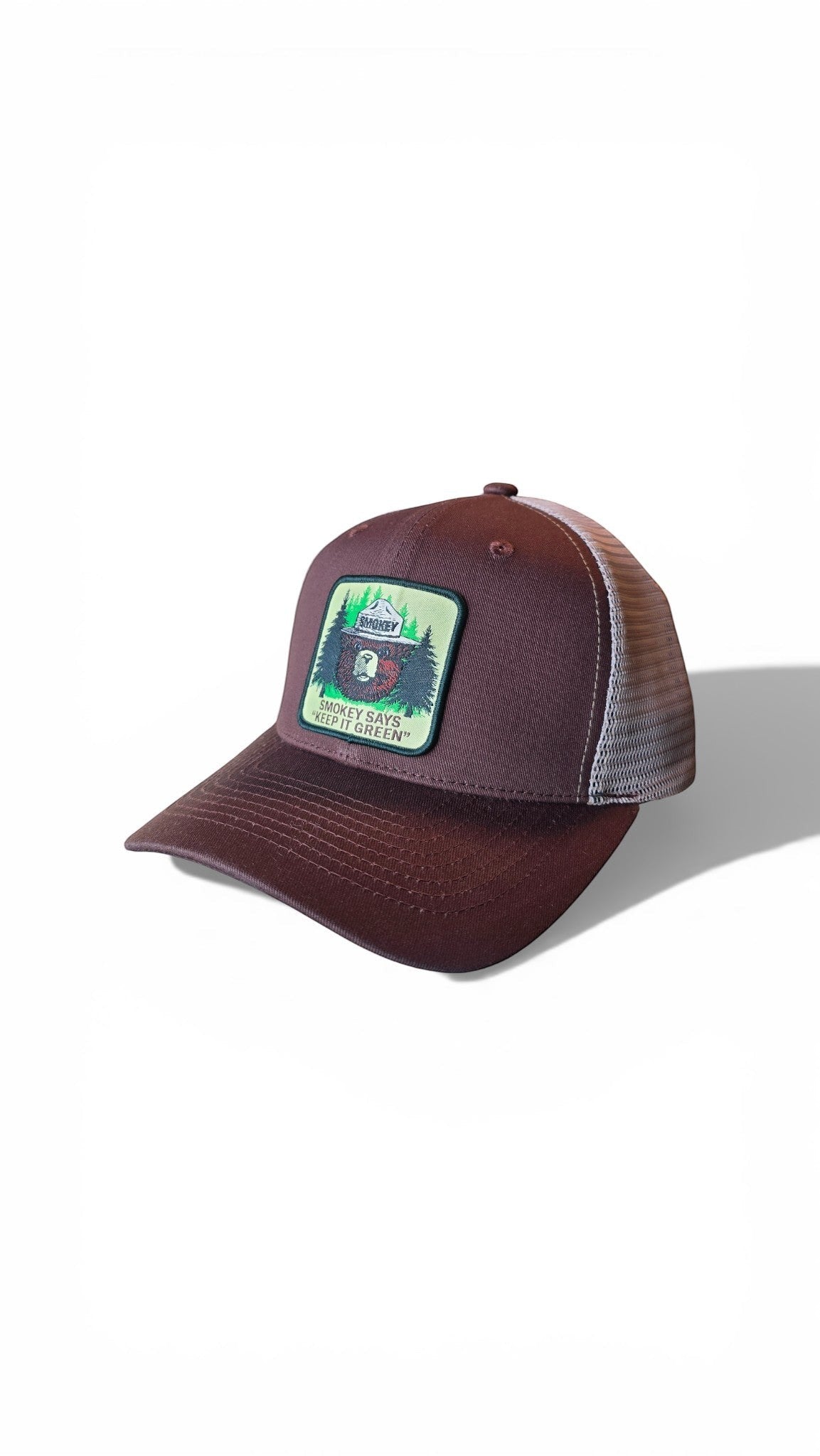 Moove Headwear brown trucker cap with mesh back and Smokey Bear logo patch promoting fire safety.
