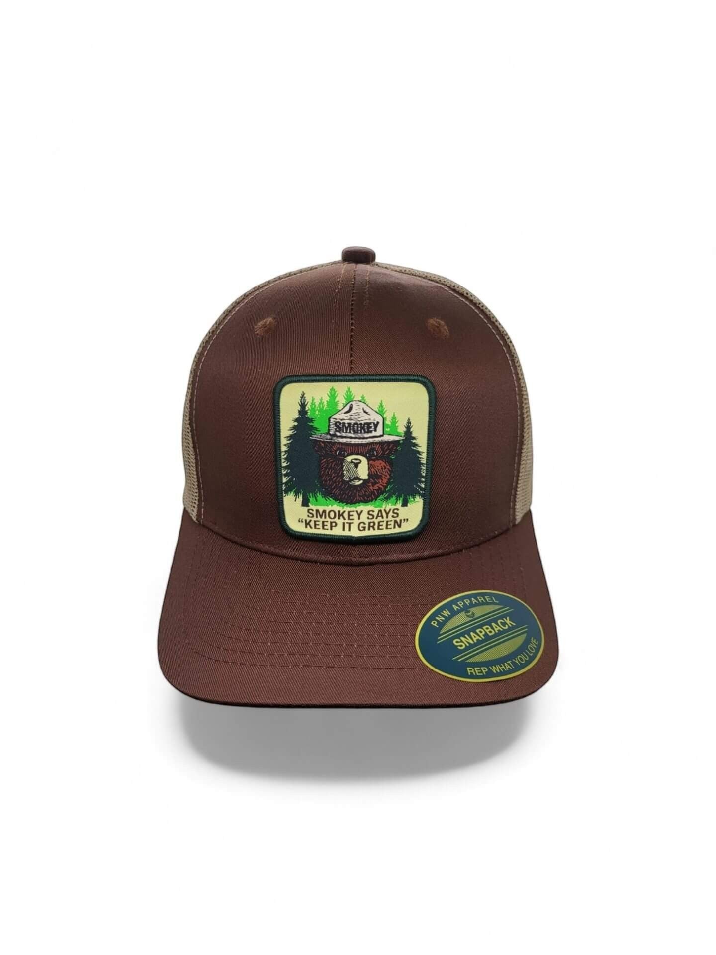 Moove Headwear brown trucker hat with mesh back, featuring a Smokey Bear logo patch promoting fire safety.