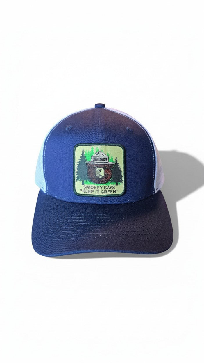 Moove Headwear navy blue trucker cap with white mesh back and Smokey Bear patch. Adjustable snapback.
