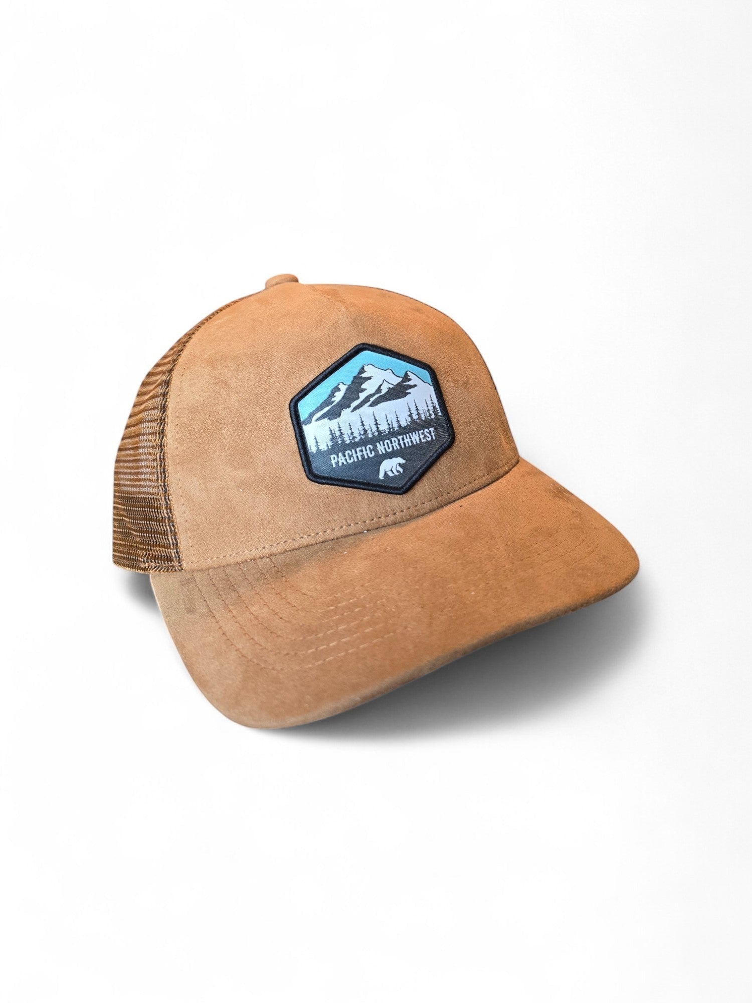 Moove Headwear tan suede trucker hat with mesh back and Pacific Northwest mountain patch. Adjustable snapback.