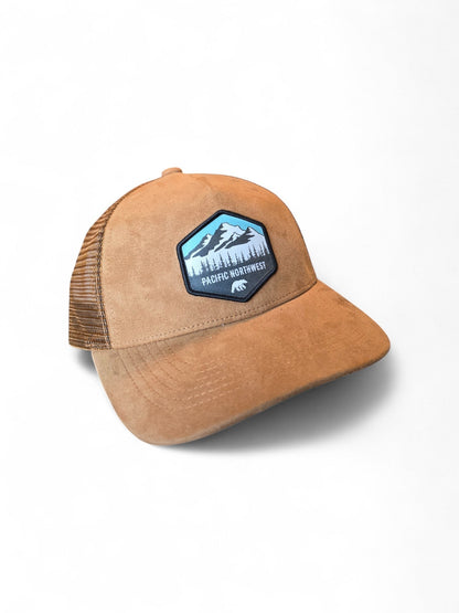 Moove Headwear tan suede trucker hat with mesh back and Pacific Northwest mountain patch. Adjustable snapback.