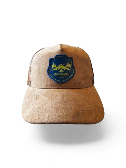 Moove Headwear tan suede trucker hat with mesh back and PNW Apparel mountain patch. Adjustable snapback.