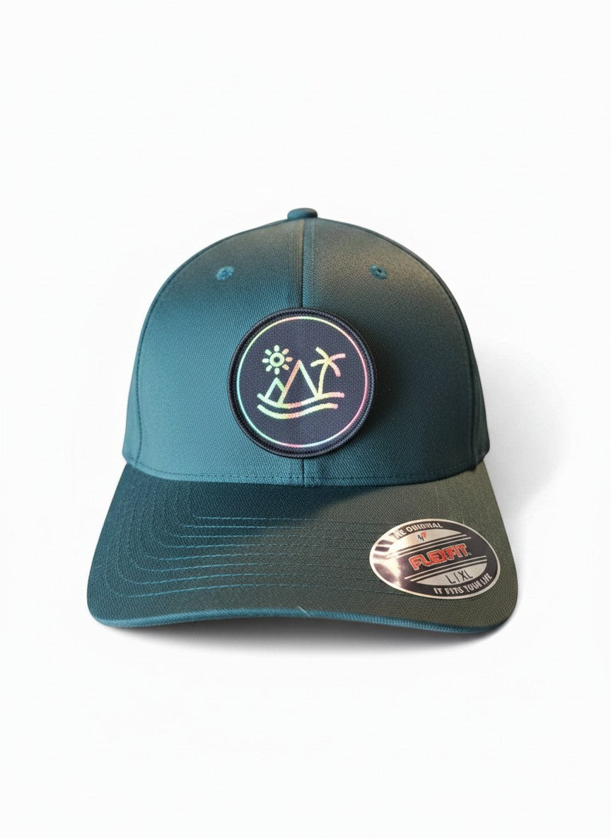 Moove Headwear fitted hat with tropical patch featuring palm tree, sun, and waves. Teal cap with Flexfit technology.