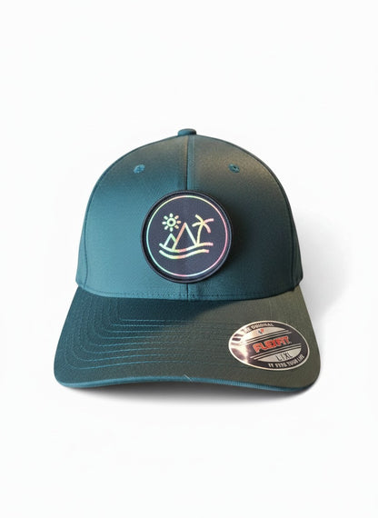 Moove Headwear fitted hat with tropical patch featuring palm tree, sun, and waves. Teal cap with Flexfit technology.