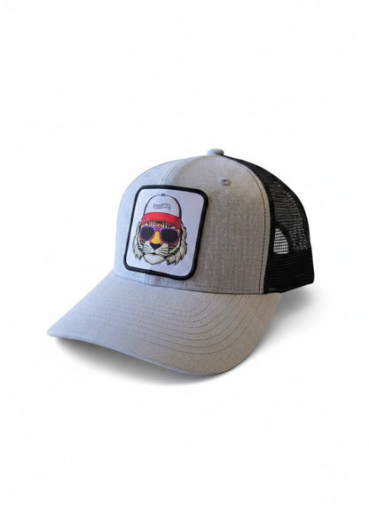 Moove Headwear light grey trucker hat with black mesh back and embroidered tiger patch wearing sunglasses and a red headband.