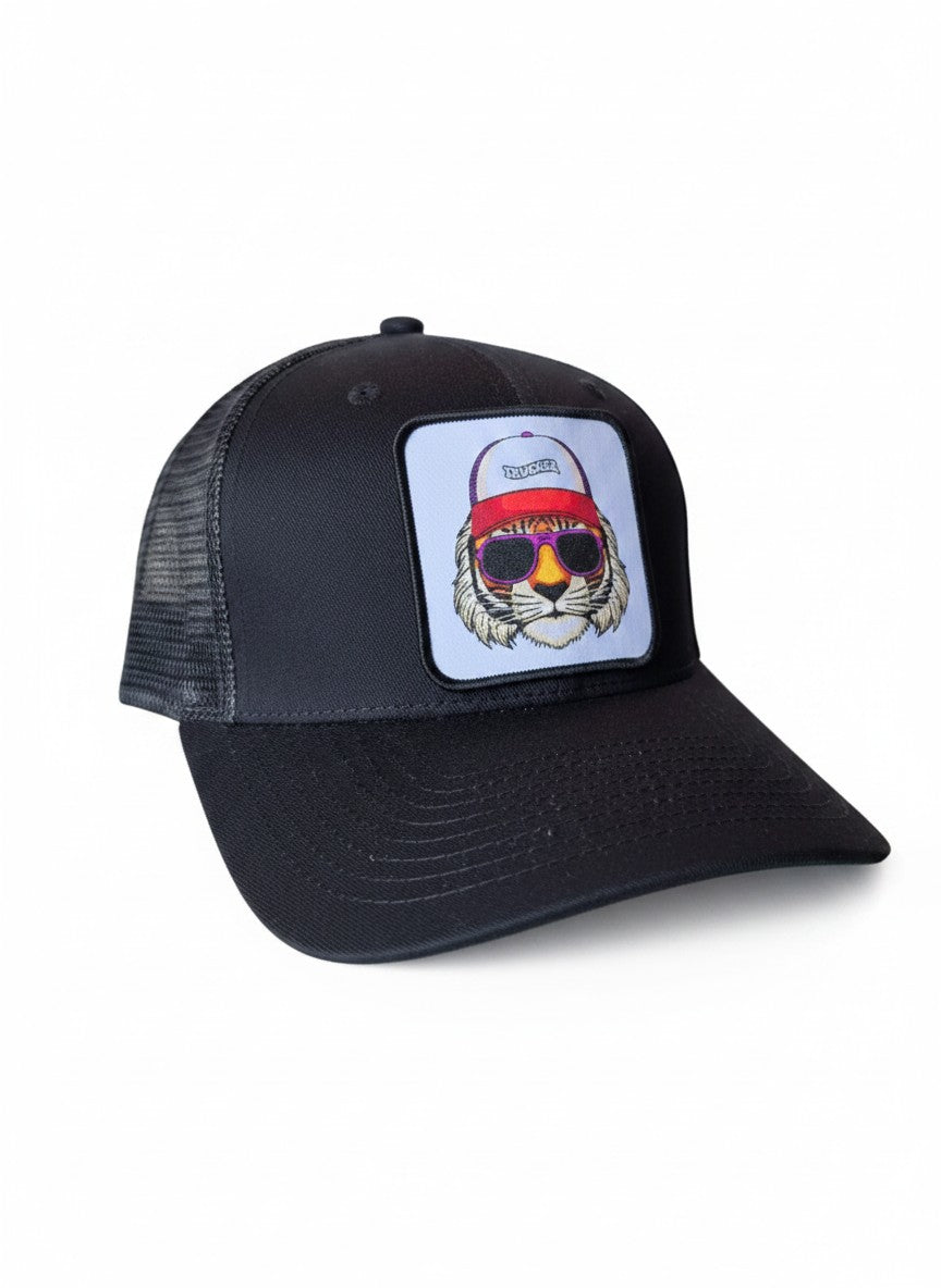 Moove Headwear black trucker hat with a patch of a tiger wearing sunglasses and a red headband. Features mesh backing and adjustable snapback.