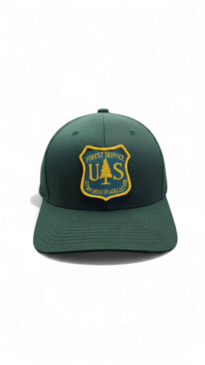 Moove Headwear dark green fitted baseball cap with US Forest Service patch and curved brim.