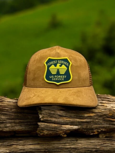 Moove Headwear USFS Ranger Trucker Hat in tan suede with mesh back and embroidered US Forest Service patch.