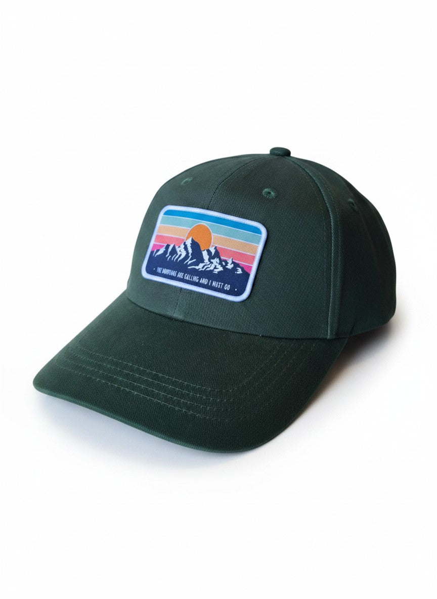 Moove Headwear dark green dad hat with a retro mountain sunset patch and adjustable brass buckle.
