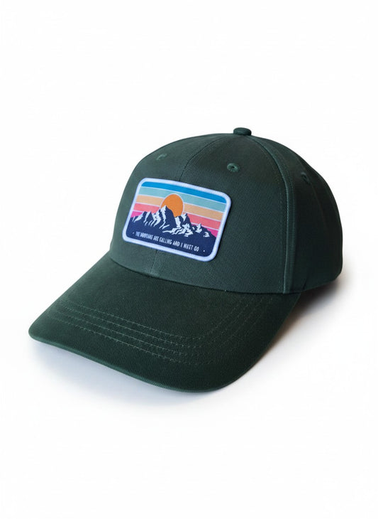 Moove Headwear dark green dad hat with a retro mountain sunset patch and adjustable brass buckle.