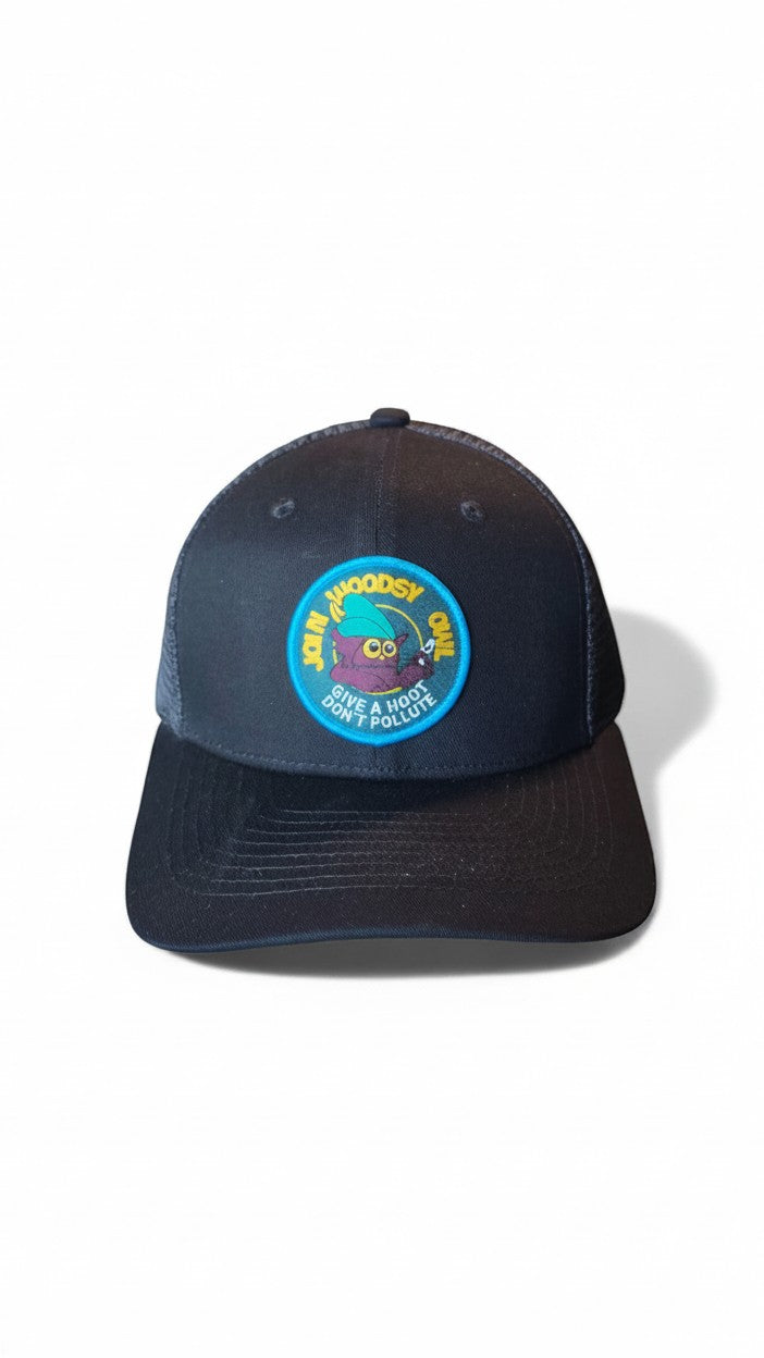 Moove Headwear black trucker hat with Woodsy Owl graphic patch promoting conservation. Features mesh back and adjustable snapback.