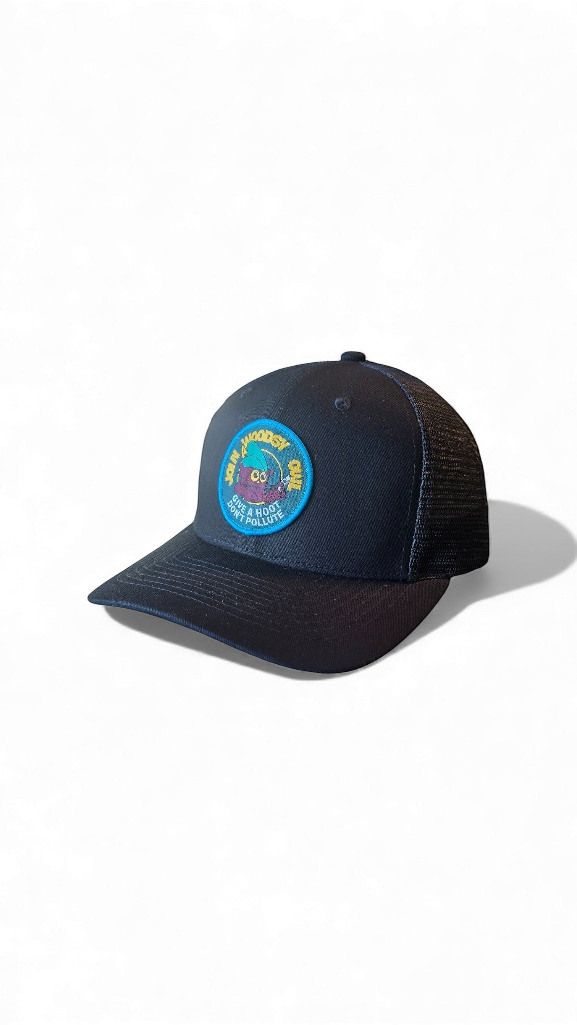 Moove Headwear black trucker hat with a circular Woodsy Owl patch promoting conservation. Features mesh back and adjustable snapback.