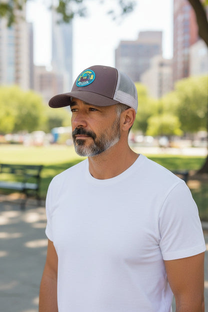 Moove Headwear brown trucker hat with mesh back and Woodsy Owl graphic, adjustable snapback closure.