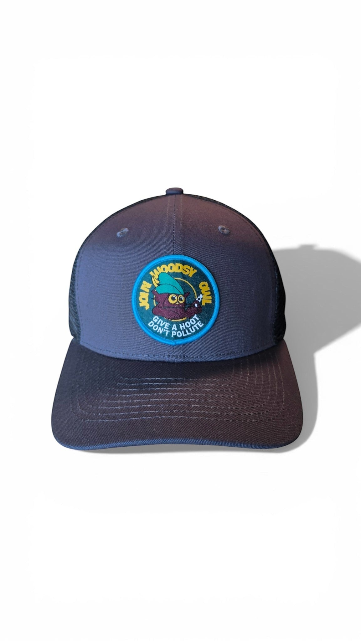 Moove Headwear navy blue trucker hat with a circular Woodsy Owl patch and mesh back. Adjustable snapback.