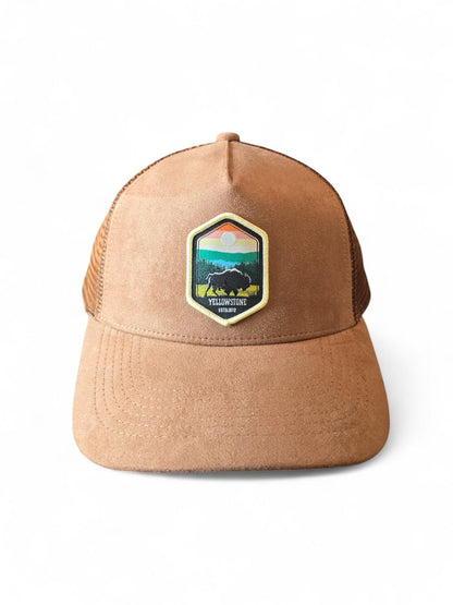 Moove Headwear tan suede trucker hat with Yellowstone National Park buffalo emblem and mesh back.