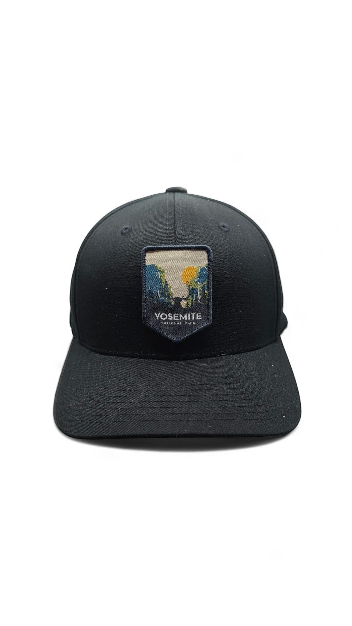 Moove Headwear black fitted cap with Yosemite National Park embroidered patch featuring a scenic mountain landscape and deer.