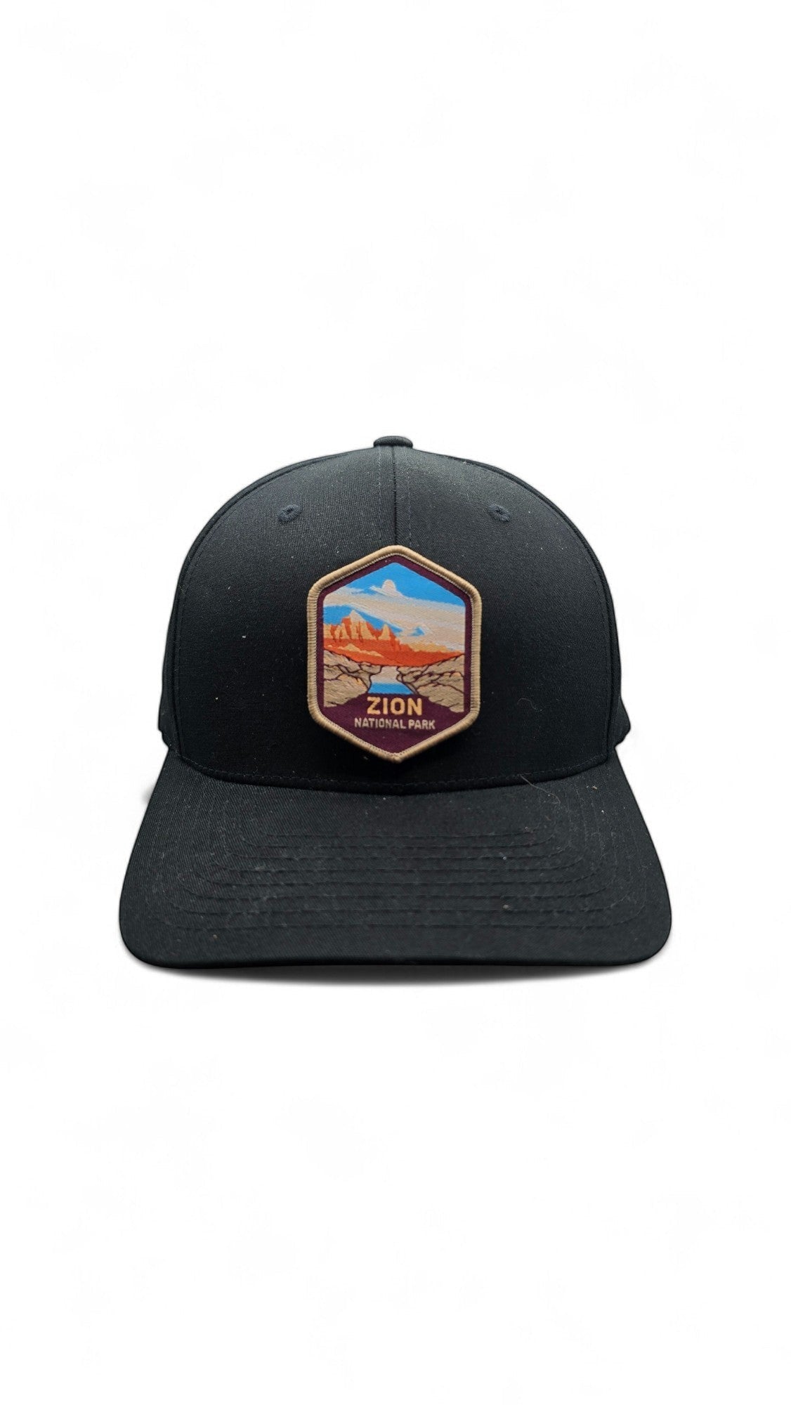 Moove Headwear black adjustable baseball cap with embroidered Zion National Park patch. Features a landscape scene with mountains and a river.