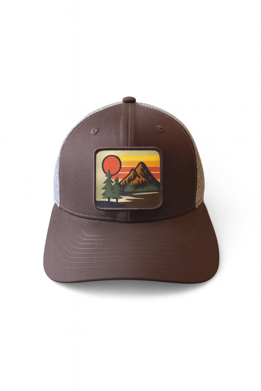 Brown and tan vintage trucker hat with retro embroidered mountain and sunset patch, mesh back, and snapback closure"